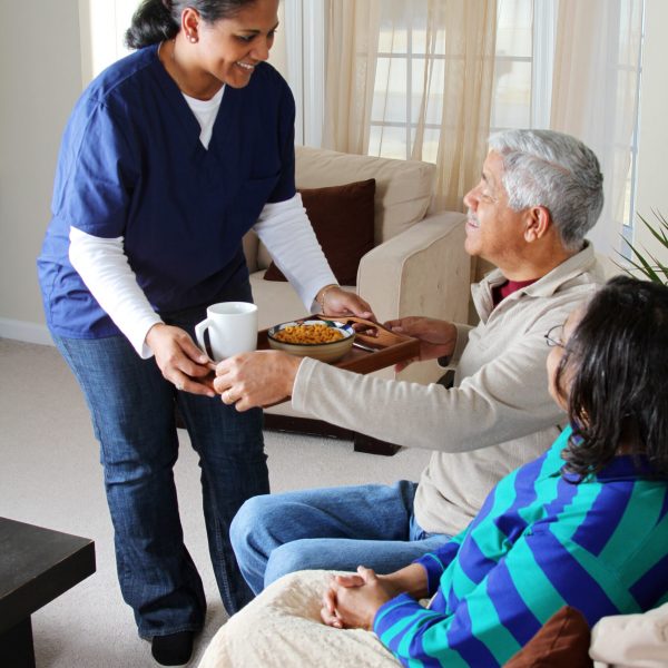 Home health care worker and an elderly couple