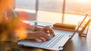 woman writing on laptop